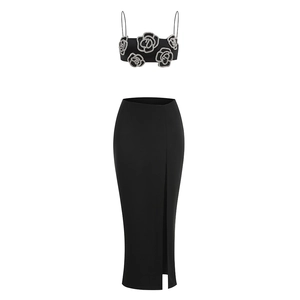 Detail of black camisole top with rhinestone rose pattern and matching split skirt