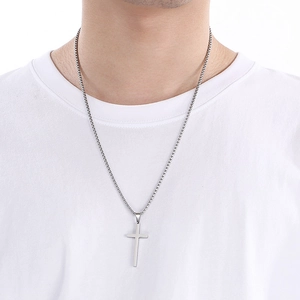 Polished silver stainless steel cross pendant necklace on model with box chain detail