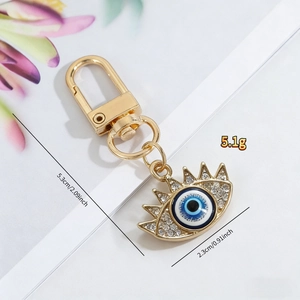 Detailed view of evil eye keychain showing 5.3cm length and rhinestone accents