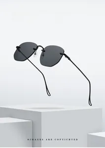 Detail of rimless hexagonal black sunglasses with ultra-thin metal temples on white stand