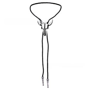 Close-up of vintage silver bull skull bolo tie with black braided leather cord and metal tips
