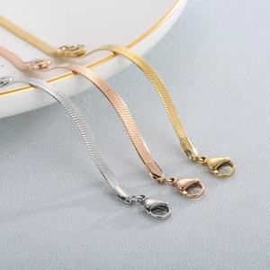 Flat 4mm stainless steel blade chain bracelet with infinity symbol in gold, silver and rose gold