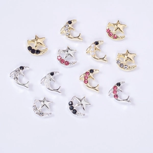 Star, moon, and dolphin nail art charms with colorful rhinestones on white background