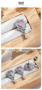 Detail of heart wing ear studs with pink and blue gemstones and pear-shaped drop pendants