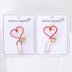 Detail of heart stethoscope brooches in red and black with gold plating and rhinestones