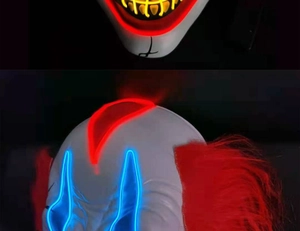 Macro detail of LED glowing clown mask showing red hair and colorful light wires