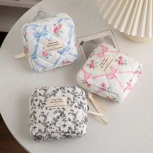 Quilted ribbon bow cosmetic bags in floral patterns for makeup and stationery storage