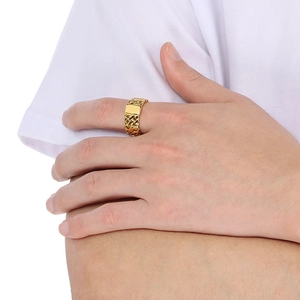 Detail of a wide gold hammered texture stainless steel ring on a male model's finger
