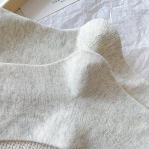 Close-up of light gray ribbed knit socks showing breathable cotton texture and soft finish