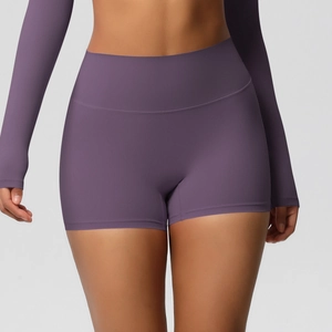 Macro shot of high-waist purple yoga shorts showing brushed texture and seamless sewing