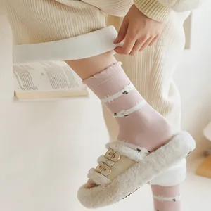 Close-up of pink cotton mid-calf socks with sheep pattern and wavy scalloped edge