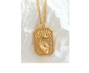 Detailed relief of hand holding a crescent moon on a gold rectangular pendant necklace