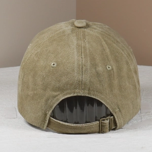 Detail of light khaki corduroy baseball cap with an adjustable metal buckle and strap