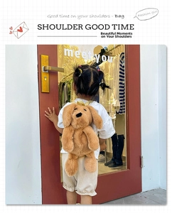 Detail of toddler wearing a plush dog backpack with soft brown fur and yellow straps
