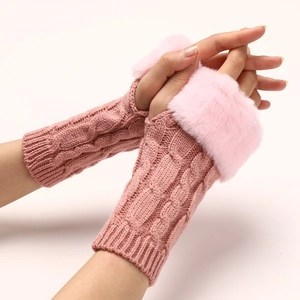Detail of pink knitted fingerless gloves with soft faux fur cuffs and cable knit texture
