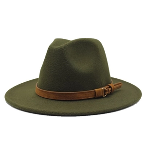 Detail of dark green fedora hat featuring a brown suede band and metallic ring tassel