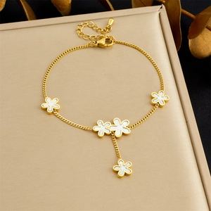 Delicate gold chain bracelet with five white enamel flowers and adjustable lobster clasp