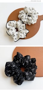 Detailed view of polka dot bow scrunchies on a wooden tray with contrast trim fabric