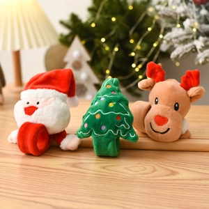 Plush Christmas slap bracelets featuring Santa, Reindeer, and Tree on a wooden table
