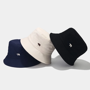 Minimalist cotton bucket hats with polar bear embroidery in navy, beige, and black