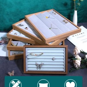 Detailed view of stacked wooden jewelry display trays with soft microfiber velvet lining