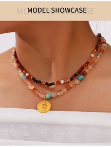 Close-up detail of bohemian multi-layered natural stone beaded gold-plated necklace.