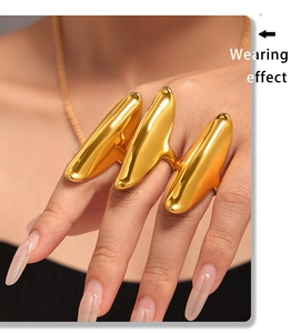 Close-up of polished gold irregular multi-finger open ring showing unique wearing effect