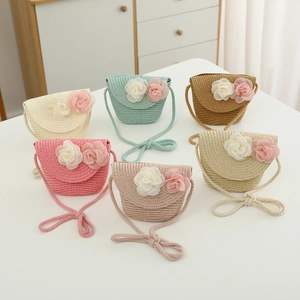 Detail of colorful children straw bags with floral decor and textured weave patterns