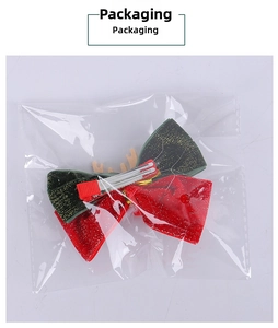 Close-up of Christmas reindeer antler hair clip with bow in clear OPP packaging