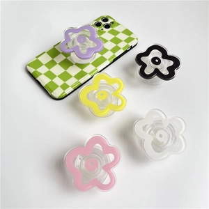 Flat lay of colorful flower-shaped phone sockets in purple, pink, and yellow hues