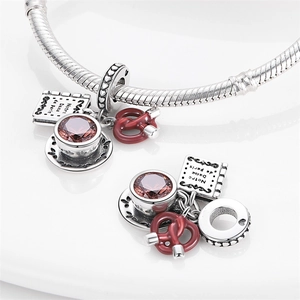 Silver afternoon tea charm bracelet with coffee cup and Notre Dame book pendant
