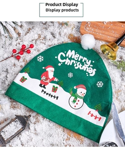 Close-up of green felt Christmas car seat cover with Merry Christmas print and plush ball
