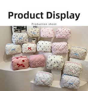 Detailed close-up of various quilted cotton makeup bags with floral and cherry patterns