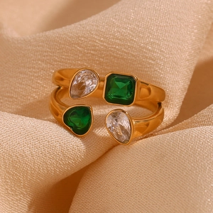 Macro shot of 18K gold plated ring with teardrop zircon and heart emerald gemstones