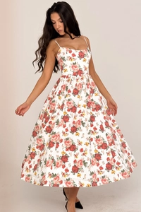 Detail of white midi dress with floral print featuring thin spaghetti straps and sweetheart neckline