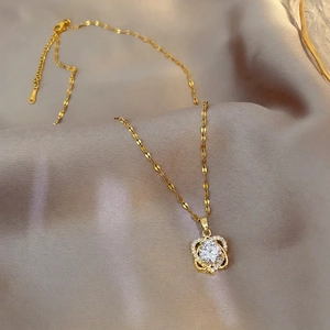 Elegant gold titanium steel necklace featuring a hollow flower pendant with a round crystal