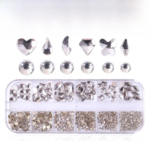 Close-up of 12-slot storage box with various shaped clear glass nail art crystals