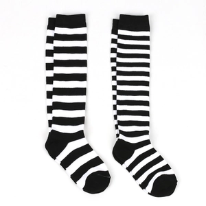 Detail of high knee-high striped socks in classic black and white knit pattern