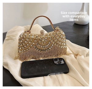 Size comparison of sparkling gold evening clutch bag with rhinestones and tassels
