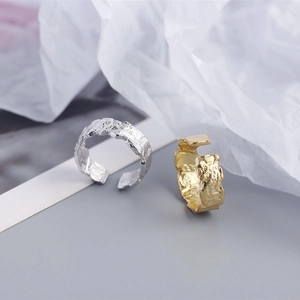 Close-up of S925 sterling silver rings with irregular hammered foil texture in gold and silver