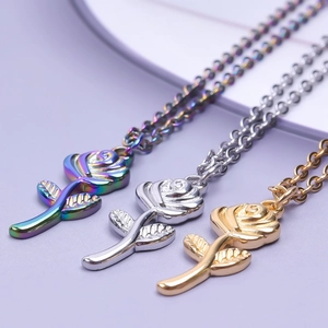 Macro shot of rose petal pendants in gold, silver, and rainbow stainless steel finishes