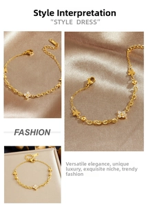 Detailed view of the gold chain bracelet with clover charms on premium silk texture