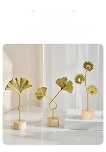 Three-piece set of golden metal ginkgo leaf and sunflower ornaments with wooden bases