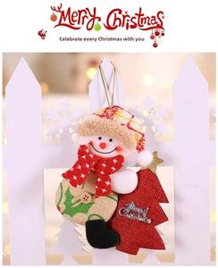 Detail of plush Christmas snowman ornament with red plaid hat and Merry Christmas sign