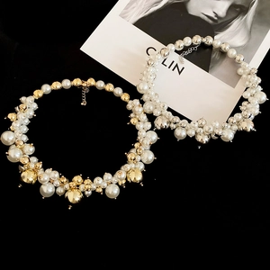 Close-up of elegant irregular pearl and metallic bead necklace with adjustable lobster clasp