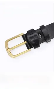 Detail of black TPU belt showing golden alloy buckle and cross decorative stitching
