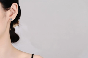 Classic moissanite stud earring on ear model showing scale and elegant design