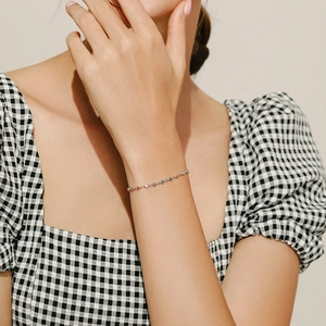 925 sterling silver bracelet with rainbow gemstone charms on a model's wrist