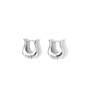 Detailed view of silver irregular curved earrings with a high-shine metallic finish