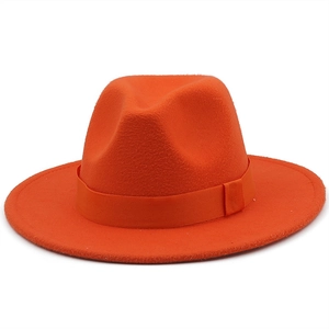 Detailed close-up of vibrant orange wool fedora with matching grosgrain ribbon band